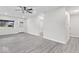 Another view of the bright living room with wood-look flooring and multiple doorways at 5410 Bertha St, Indianapolis, IN 46241