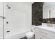 Bathroom boasts white tile, a patterned accent wall, and a marble-topped vanity at 5615 Brouse Ave, Indianapolis, IN 46220