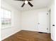 Empty bedroom with polished wood floors, white walls, and a ceiling fan at 5615 Brouse Ave, Indianapolis, IN 46220