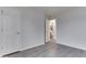 Empty bedroom with gray wood-look floors and open door to a bathroom at 5810 Spring Oaks Way, Indianapolis, IN 46237