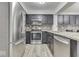 Kitchen boasts stainless steel appliances, dark cabinets, and tile flooring at 5810 Spring Oaks Way, Indianapolis, IN 46237