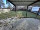 Backyard with gravel and grass areas, covered structure, and wood fence at 6215 E 11Th St, Indianapolis, IN 46219