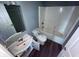 Simple bathroom with a bathtub/shower combo, single vanity, and toilet at 6215 E 11Th St, Indianapolis, IN 46219