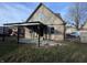 Back of the house features a covered patio area with gravel and grass at 6215 E 11Th St, Indianapolis, IN 46219