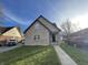 Charming two-story home with brick and siding exterior, front yard, and walkway at 6215 E 11Th St, Indianapolis, IN 46219