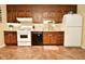 Bright kitchen featuring wood cabinets, white appliances, and a tiled floor at 6736 Carlsen Ave, Indianapolis, IN 46214