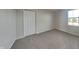 Empty bedroom featuring neutral walls, carpeted flooring, a closet, and a window at 7056 E Mardenis N Dr, Camby, IN 46113