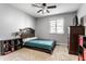 Cozy bedroom with a comfortable bed, ceiling fan, and ample storage space at 7609 Home Dr, Fishers, IN 46038