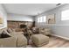 Cozy living room featuring a brick fireplace, comfortable seating, and wood-look flooring at 7609 Home Dr, Fishers, IN 46038