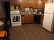 Galley kitchen with wood cabinets and laminate floor at 8315 E 36Th Pl, Indianapolis, IN 46226