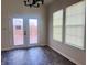 Dining room with French doors, blinds, and dark wood-look flooring at 8428 Gates Corner Dr, Camby, IN 46113