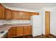 Kitchen with ample wood cabinetry, stainless steel appliances, and wood-look floor at 8613 Midsummer Dr, Indianapolis, IN 46239