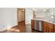 View of the kitchen's stainless steel dishwasher and wood-look flooring at 8613 Midsummer Dr, Indianapolis, IN 46239