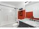 Bathroom with marble vanity, white tub/shower combo, and bold red accent wall at 878 Cherry Tree Ln, Greenwood, IN 46143