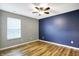 Bedroom with wood-look flooring and a blue accent wall at 878 Cherry Tree Ln, Greenwood, IN 46143