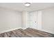 Bright basement room featuring wood-look floors and neutral walls at 4360 Guilford Ave, Indianapolis, IN 46205