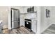 Bright kitchen with stainless steel appliances and white cabinetry at 4360 Guilford Ave, Indianapolis, IN 46205