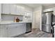 Renovated kitchen, boasting stainless steel appliances and white cabinets at 4360 Guilford Ave, Indianapolis, IN 46205