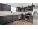 Modern kitchen with stainless steel appliances and dark cabinetry at 10107 Falls Canyon Ln, Indianapolis, IN 46229