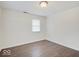 Simple bedroom with wood-look floors and one window at 1035 Helen Dr, Indianapolis, IN 46240