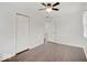 Well-lit bedroom with wood floors, double closet, and additional access at 1035 Helen Dr, Indianapolis, IN 46240