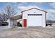 White metal garage with large overhead door and side shelters at 11197 N Gasburg Rd, Mooresville, IN 46158