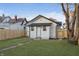 Charming backyard with a newly constructed white cottage and a brick pathway at 1127 E Kelly St, Indianapolis, IN 46203