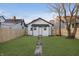 Charming backyard with a newly constructed white cottage and a brick pathway at 1127 E Kelly St, Indianapolis, IN 46203