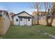 Charming backyard with a newly constructed white cottage and a brick pathway at 1127 E Kelly St, Indianapolis, IN 46203