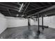 Unfinished basement area with exposed ceiling beams and grey flooring at 1127 E Kelly St, Indianapolis, IN 46203