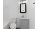 Clean bathroom with a grey vanity and a mirror at 1127 E Kelly St, Indianapolis, IN 46203