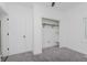 Bedroom with grey carpet, closet, and white door at 1127 E Kelly St, Indianapolis, IN 46203