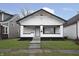 Renovated white bungalow with black accents and a well-maintained lawn at 1127 E Kelly St, Indianapolis, IN 46203