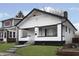 Charming white bungalow with black accents, steps, and a manicured lawn at 1127 E Kelly St, Indianapolis, IN 46203