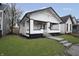 Updated white bungalow with black trim and a welcoming front porch at 1127 E Kelly St, Indianapolis, IN 46203
