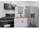 Modern kitchen features stainless steel appliances and white shaker cabinets at 1127 E Kelly St, Indianapolis, IN 46203