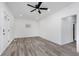 Spacious living room featuring gray flooring and a modern ceiling fan at 1127 E Kelly St, Indianapolis, IN 46203