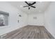 Bright living room with gray flooring, ceiling fan, and recessed lighting at 1127 E Kelly St, Indianapolis, IN 46203