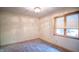 Spacious bedroom with neutral walls, gray carpet, and a large window at 1865 Inisheer Ct, Indianapolis, IN 46217