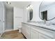 Modern bathroom with double vanity, marble countertops and walk-in shower at 202 Asbury Dr, Anderson, IN 46013