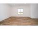 Bright bedroom with hardwood floors and large window at 202 Asbury Dr, Anderson, IN 46013