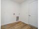 Bright laundry room with vinyl flooring and built-in cabinets at 202 Asbury Dr, Anderson, IN 46013
