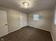 Spacious bedroom with neutral walls and carpet, featuring a double door closet at 2130 N Cherry St, Columbus, IN 47201