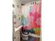 Clean bathroom with colorful shower curtain at 2307 N Catherwood Ave, Indianapolis, IN 46219