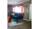 Comfortable living room with blue sofa and colorful rug at 2307 N Catherwood Ave, Indianapolis, IN 46219