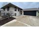 Tan ranch home with black shutters, attached garage, and landscaping at 2339 Jolinda Ct, Columbus, IN 47203