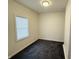 Small bedroom with dark carpet and window at 2342 Hoyt Ave, Indianapolis, IN 46203