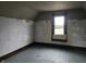 Unfinished attic room with hardwood floors and a window, perfect for DIY at 2402 N B St, Elwood, IN 46036