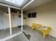 Covered porch with yellow metal table and chairs at 2732 Desoto Way, Columbus, IN 47203