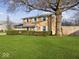 Two-story brick home with a large tree and well-manicured lawn at 2941 Taylor Rd, Columbus, IN 47203